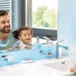 father and daughter brushing teeth